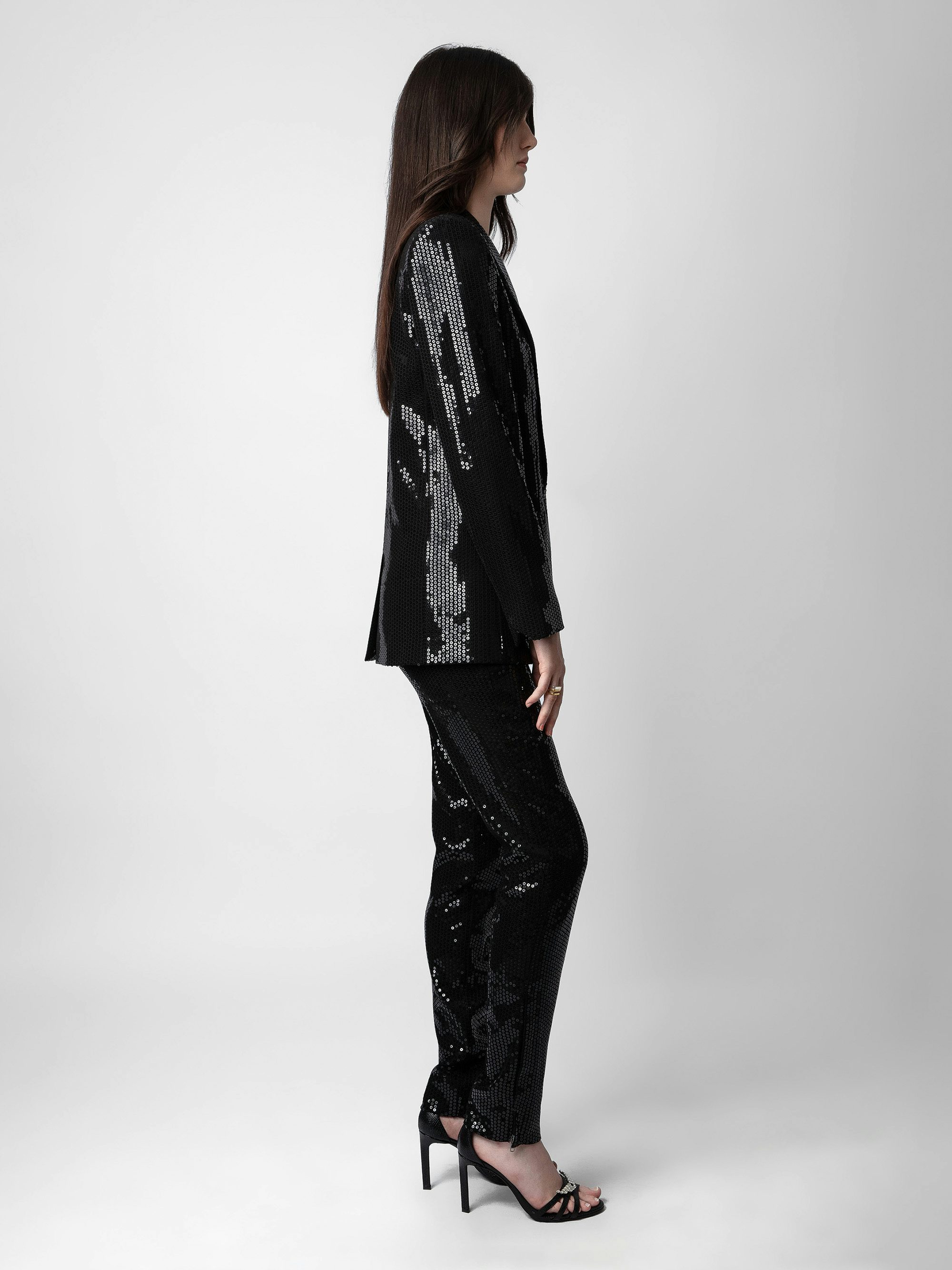 Vive Sequin Blazer - Make a bold statement with this women’s black sequin blazer, featuring a tailored fit and striking double-breasted design. Accented with a classic collar, structured shoulder pads, a fastening button, and flap pockets, this blazer combines elegance with edgy sophistication. Perfect for evening wear or adding sparkle to any outfit, it’s a must-have for a glamorous wardrobe.